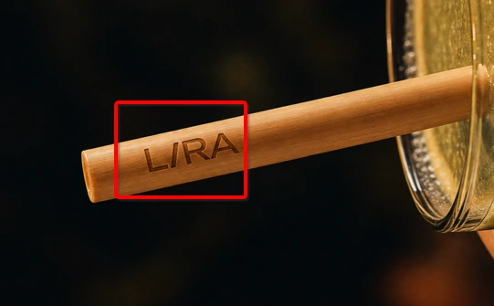 Close-up of LIRA logo laser engraved on a reed straw